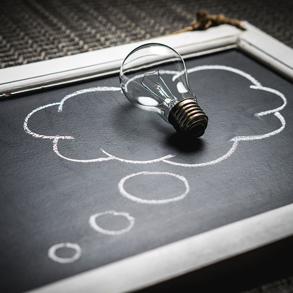 Business Law Idea Cloud and Lightbult on Chalkboard